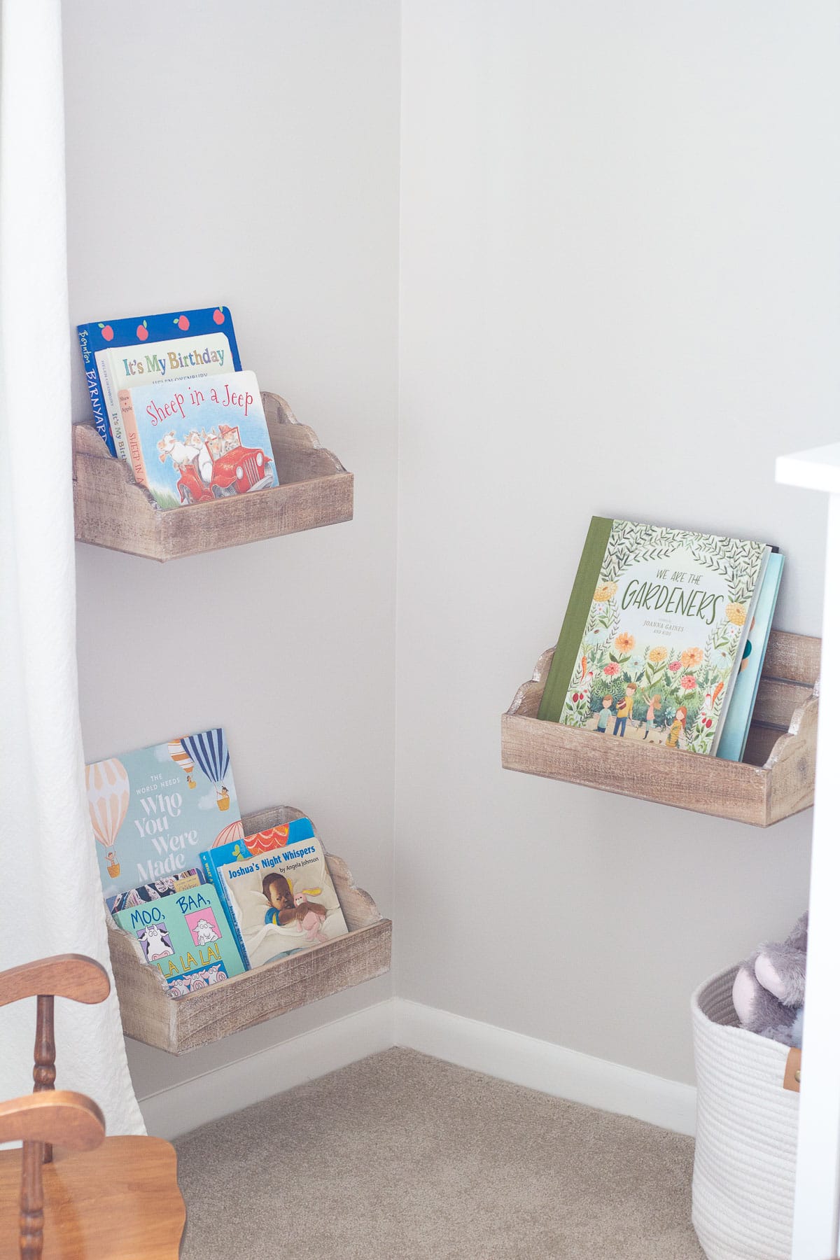 Board books displayed in ledge shelf boxes from Hobby Lobby.