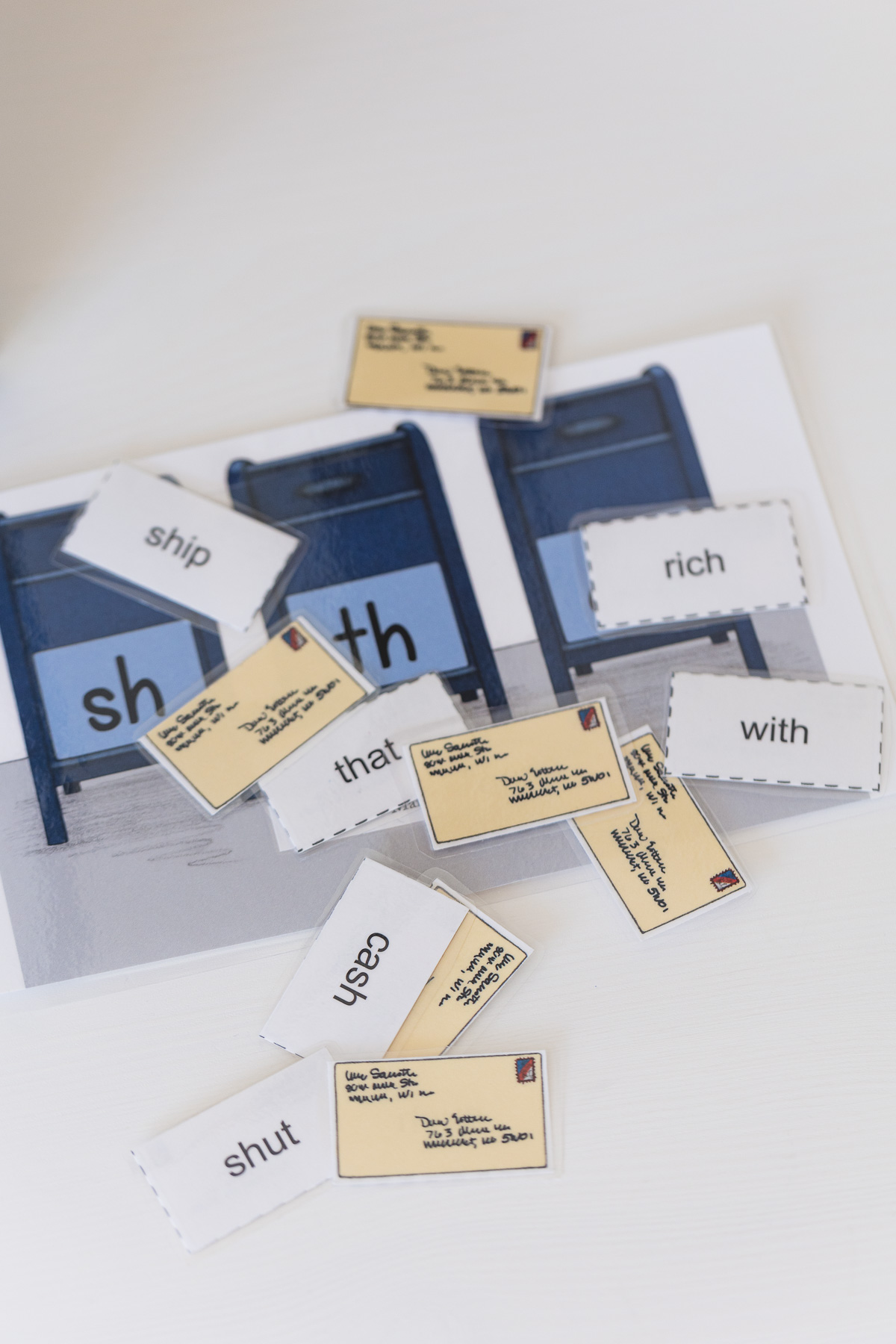 All About Reading "mailbox" word practice game pieces on a white surface.